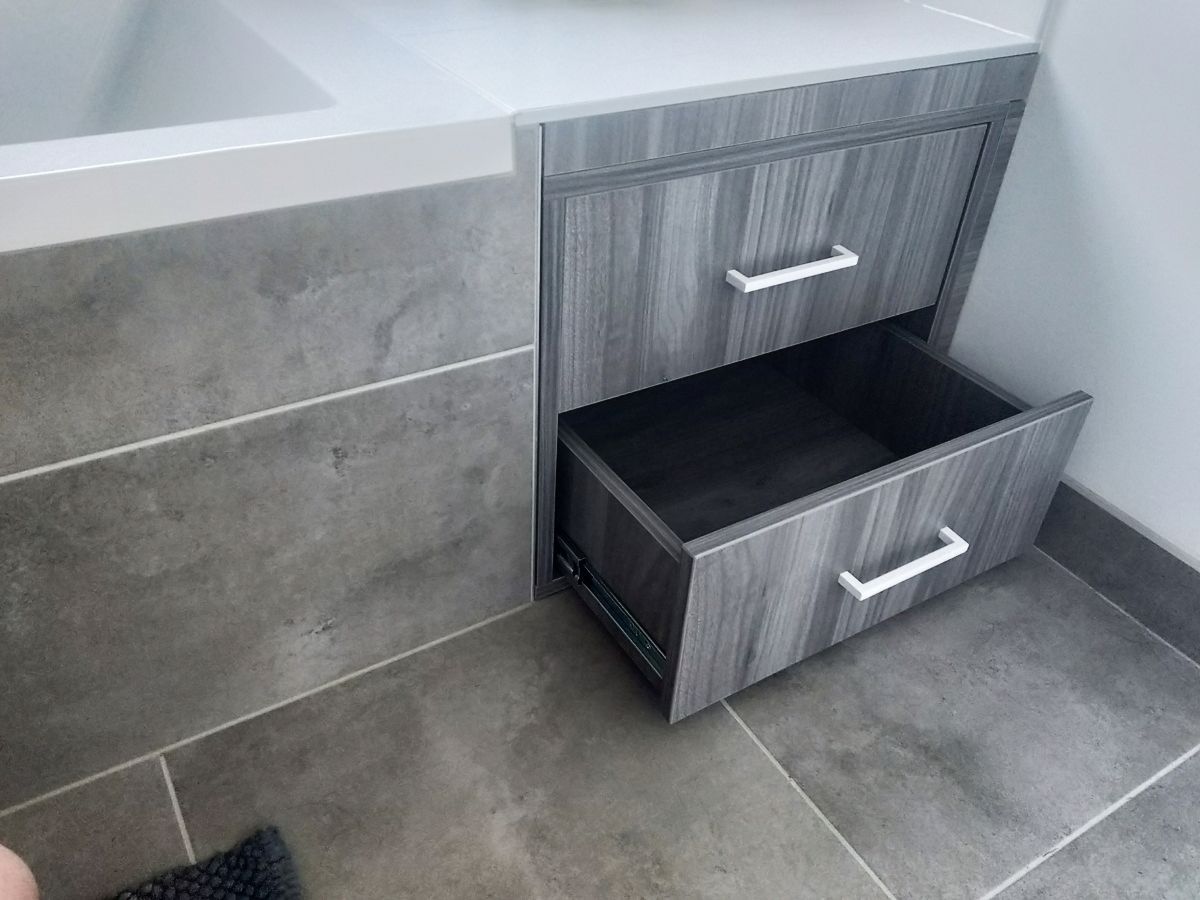 Tiroirs intégrés sous une baignoire