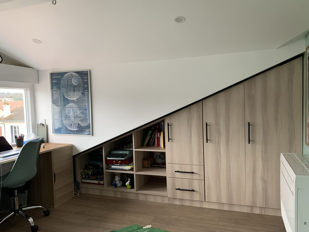 Custom sloped ceiling wardrobe with drawers and open niches