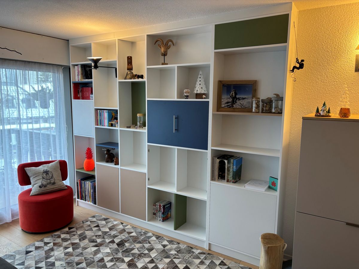 Large, colorful custom-made living room bookshelf